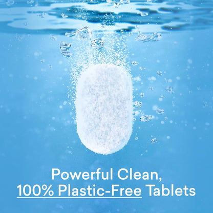White unwrapped dishwasher detergent tablet held between fingers